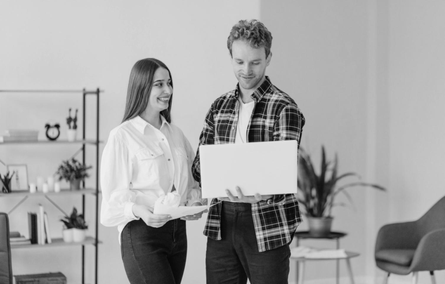 Professional analyzing business documents and charts on computer screen